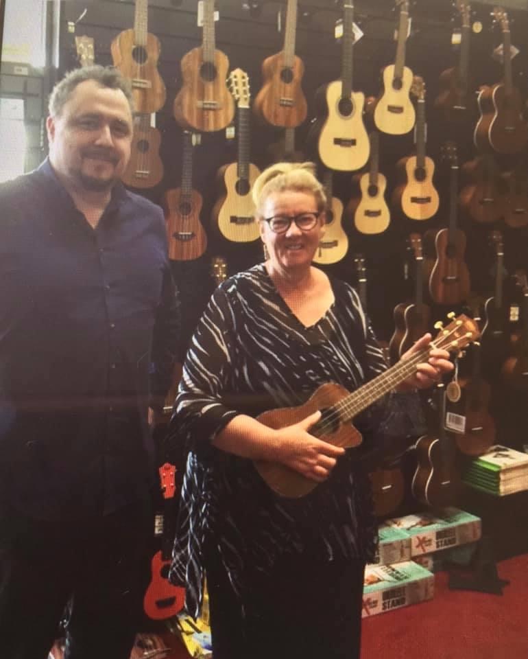 Mandy Cooper receiving her prized ukulele from Pats Music